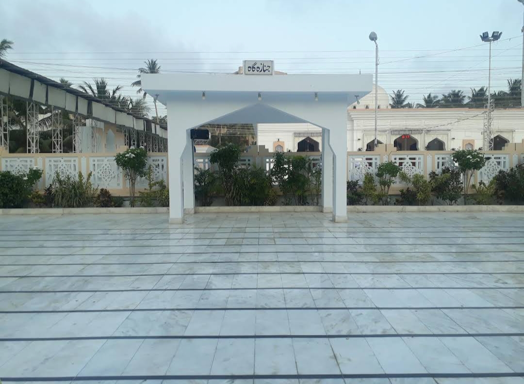 The current janazah gah at Bait ul Mukarram — modern structure with Urdu sign جنازہ گاہ, marble floor and mosque visible behind